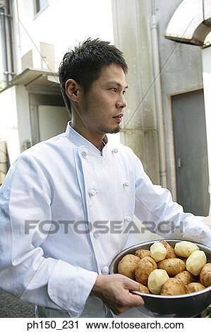Close-up of a male chef carrying a bowl of raw potatoes View Large Photo Image Stock Image - Close-up of a male chef carrying a bowl of raw potatoes. Fotosearch