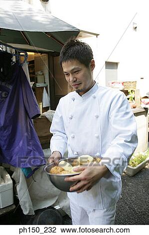Close-up of a male chef carrying a bowl of raw potatoes View Large Photo Image Stock Image - Close-up of a male chef carrying a bowl of raw potatoes. Fotosearch