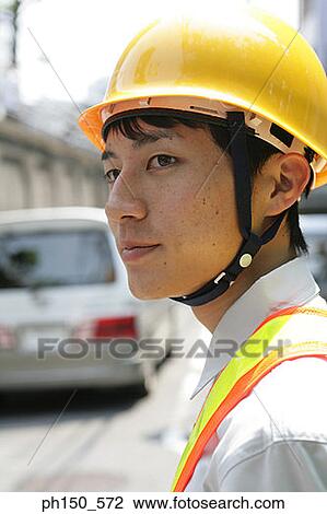 Stock Image - Close-up of a traffic cop looking sideways. Fotosearch