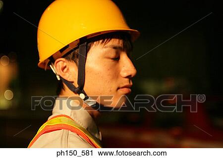 Close-up of a traffic cop wearing a hard hat View Large Photo Image Stock Image - Close-up of a traffic cop wearing a hard hat. Fotosearch