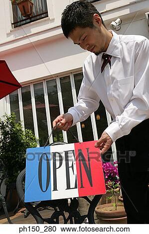 Close-up of a waiter holding an open placard View Large Photo Image Stock Image - Close-up of a waiter holding an open placard. Fotosearch