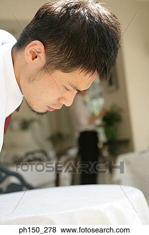 Close-up of a waiter looking at a table View Large Photo Image Stock Photo - Close-up of a waiter looking at a table. Fotosearch