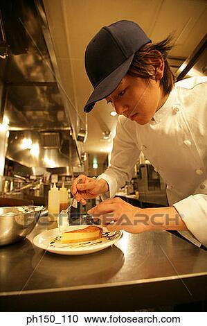Close-up of a waiter preparing food View Large Photo Image Stock Image - Close-up of a waiter preparing food. Fotosearch