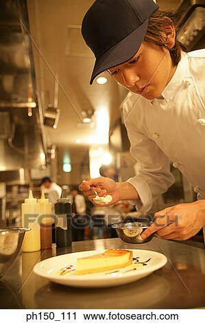Close-up of a waiter preparing food View Large Photo Image Stock Image - Close-up of a waiter preparing food. Fotosearch