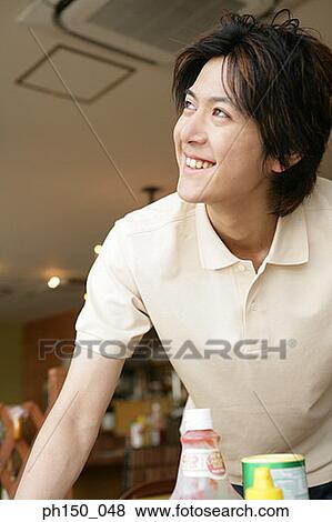 Stock Photo - Close-up of a waiter smiling. Fotosearch
