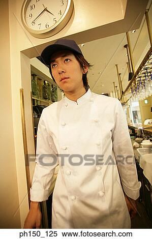 Close-up of a waiter standing in the kitchen View Large Photo Image Stock Photography - Close-up of a waiter standing in the kitchen. Fotosearch