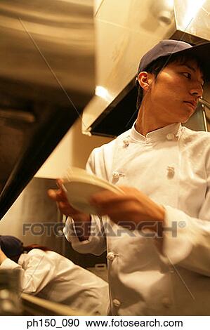 Close-up of a waiter standing with a waitress leaning behind him View Large Photo Image Stock Image - Close-up of a waiter standing with a waitress leaning behind him. Fotosearch