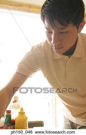 Close-up of a waiter working in a restaurant View Large Photo Image Stock Photograph - Close-up of a waiter working in a restaurant. Fotosearch