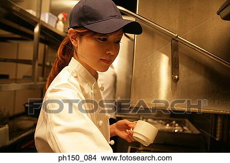 Close-up of a waitress holding a cup View Large Photo Image Picture - Close-up of a waitress holding a cup. Fotosearch