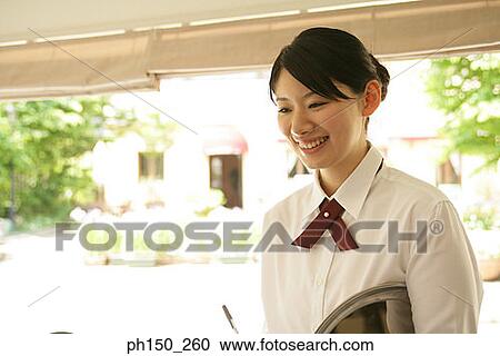 Close-up of a waitress holding a serving tray and smiling View Large Photo Image Stock Image - Close-up of a waitress holding a serving tray and smiling. Fotosearch