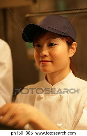 Close-up of a waitress looking away View Large Photo Image Stock Photography - Close-up of a waitress looking away. Fotosearch
