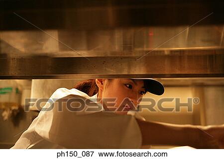 Close-up of a waitress looking down View Large Photo Image Stock Photo - Close-up of a waitress looking down. Fotosearch