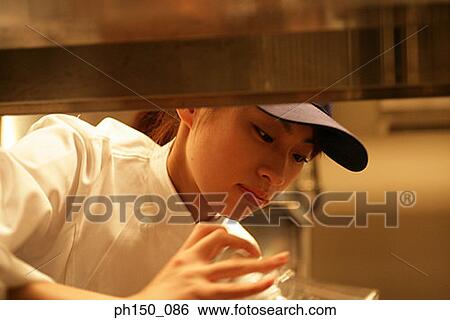 Close-up of a waitress looking down View Large Photo Image Stock Photograph - Close-up of a waitress looking down. Fotosearch
