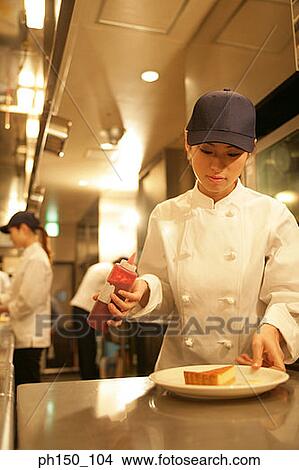 Close-up of a waitress preparing food in the kitchen View Large Photo Image Picture - Close-up of a waitress preparing food in the kitchen. Fotosearch