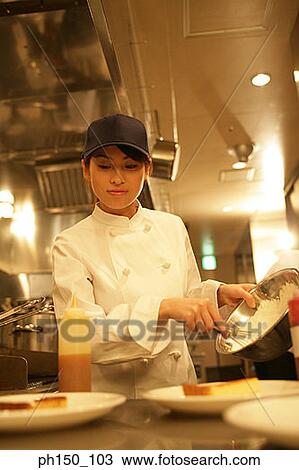 Stock Image - Close-up of a waitress serving food. Fotosearch