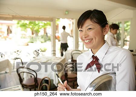 Close-up of a waitress smiling View Large Photo Image Picture - Close-up of a waitress smiling. Fotosearch