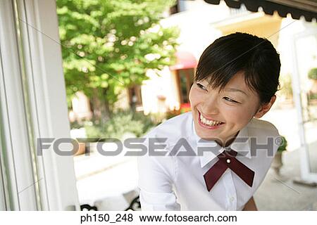 Close-up of a waitress smiling View Large Photo Image Stock Photo - Close-up of a waitress smiling. Fotosearch