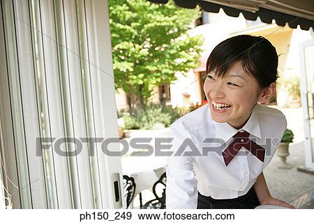 Close-up of a waitress smiling View Large Photo Image Stock Photo - Close-up of a waitress smiling. Fotosearch