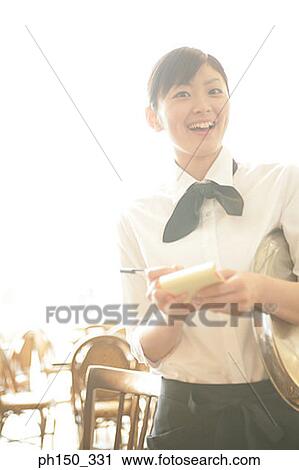 Close-up of a waitress taking an order in a restaurant View Large Photo Image Stock Image - Close-up of a waitress taking an order in a restaurant. Fotosearch