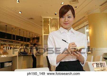 Stock Photo - Close-up of a waitress taking an order. Fotosearch