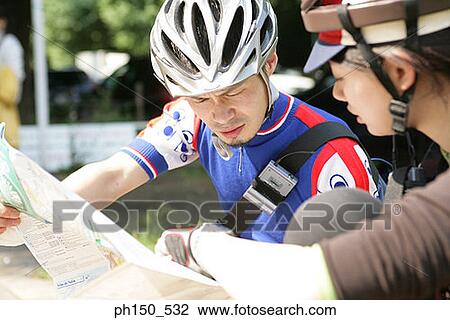 Close-up of a young couple reading a road map View Large Photo Image Stock Image - Close-up of a young couple reading a road map. Fotosearch