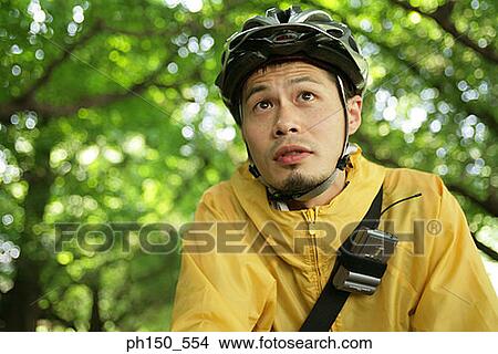 Close-up of a young man looking away View Large Photo Image Picture - Close-up of a young man looking away. Fotosearch