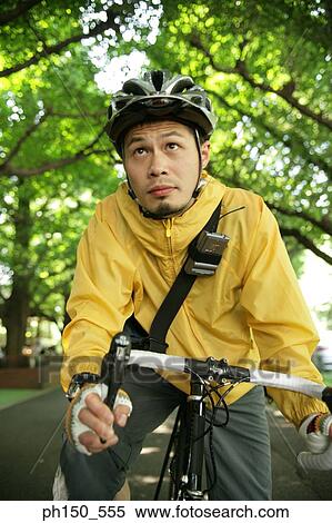 Stock Photography - Close-up of a young man riding a bicycle. Fotosearch