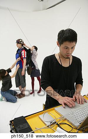 Close-up of a young man using a laptop in a film studio View Large Photo Image Stock Photo - Close-up of a young man using a laptop in a film studio. Fotosearch