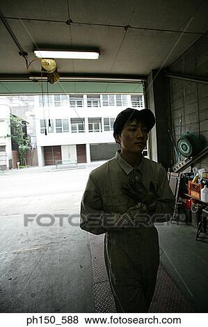 Close-up of an auto mechanic in a auto repair shop View Large Photo Image Stock Photo - Close-up of an auto mechanic in a auto repair shop. Fotosearch