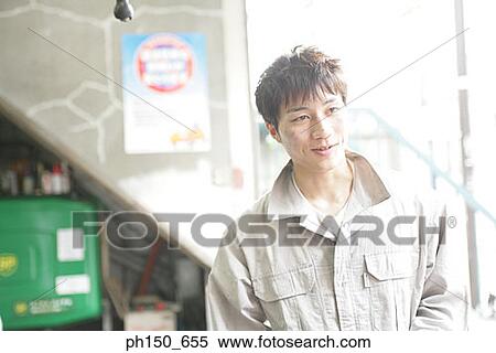 Close-up of an auto mechanic looking away View Large Photo Image Stock Photography - Close-up of an auto mechanic looking away. Fotosearch