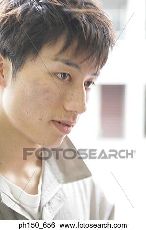 Stock Photograph - Close-up of an auto mechanic thinking. Fotosearch