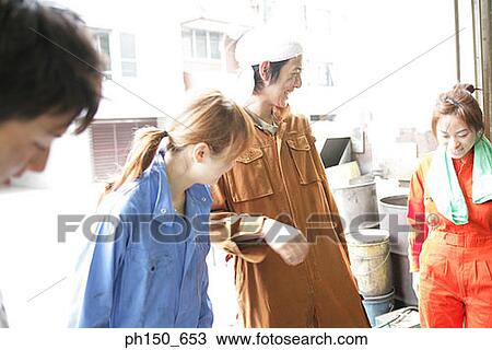 Close-up of four auto mechanics smiling View Large Photo Image Stock Image - Close-up of four auto mechanics smiling. Fotosearch