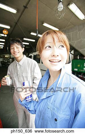 Close-up of two auto mechanics holding beer cans and smiling View Large Photo Image Stock Photograph - Close-up of two auto mechanics holding beer cans and smiling. Fotosearch