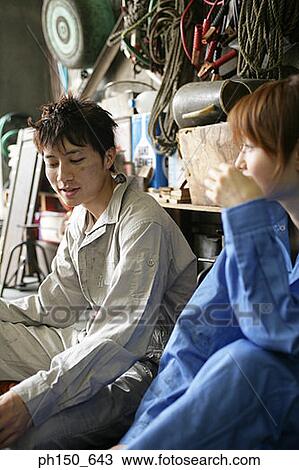 Close-up of two auto mechanics sitting in an auto repair shop View Large Photo Image Stock Image - Close-up of two auto mechanics sitting in an auto repair shop. Fotosearch