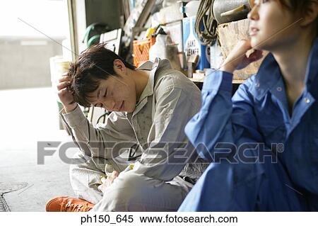 Close-up of two auto mechanics sitting in an auto repair shop View Large Photo Image Stock Photography - Close-up of two auto mechanics sitting in an auto repair shop. Fotosearch