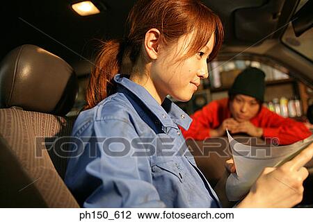 Close-up of two female auto mechanics in an auto repair shop View Large Photo Image Stock Image - Close-up of two female auto mechanics in an auto repair shop. Fotosearch