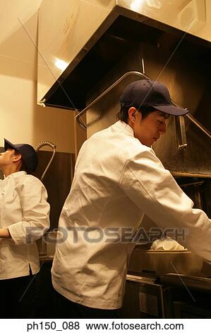 Close-up of two waiters standing in the kitchen View Large Photo Image Stock Photo - Close-up of two waiters standing in the kitchen. Fotosearch