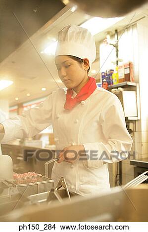 Female chef cooking food in the kitchen View Large Photo Image Picture - Female chef cooking food in the kitchen. Fotosearch