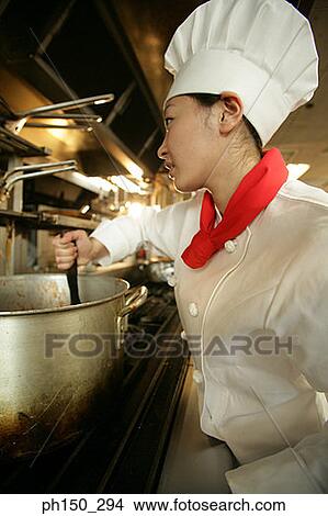 Female chef cooking in the kitchen View Large Photo Image Picture - Female chef cooking in the kitchen. Fotosearch