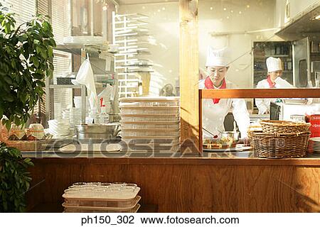 Female chef decorating a tart with a slice of strawberry and a chef standing in the background View Large Photo Image Stock Image - Female chef decorating a tart with a slice of strawberry and a chef standing in the background. Fotosearch