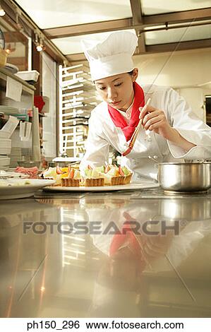 Female chef preparing a strawberry tart in a restaurant View Large Photo Image Stock Photograph - Female chef preparing a strawberry tart in a restaurant. Fotosearch