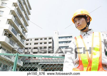 Low angle view of a female traffic cop looking away View Large Photo Image Stock Photograph - Low angle view of a female traffic cop looking away. Fotosearch