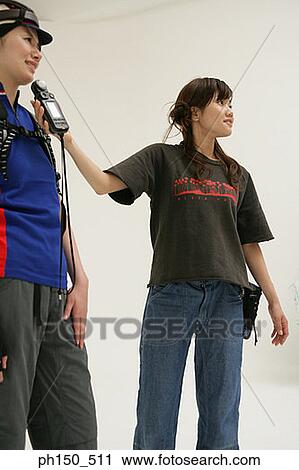 Low angle view of a photographer using a light meter in front of a female fashion model View Large Photo Image Stock Image - Low angle view of a photographer using a light meter in front of a female fashion model. Fotosearch
