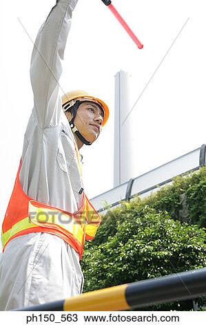 Low angle view of a traffic cop holding a nightstick View Large Photo Image Stock Image - Low angle view of a traffic cop holding a nightstick. Fotosearch