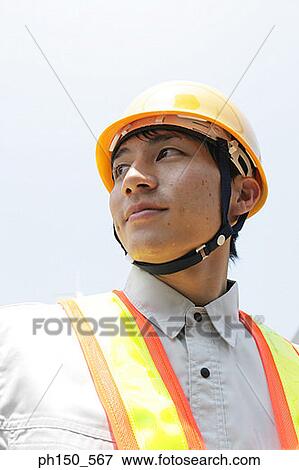 Low angle view of a traffic cop looking away View Large Photo Image Stock Photo - Low angle view of a traffic cop looking away. Fotosearch