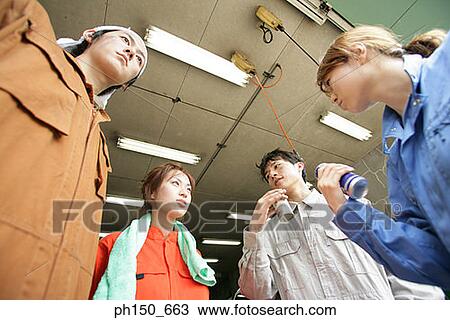 Low angle view of four auto mechanics standing in an auto repair shop View Large Photo Image Stock Image - Low angle view of four auto mechanics standing in an auto repair shop. Fotosearch
