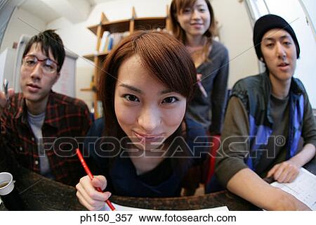 Stock Photo - Portrait of a businesswoman with her colleges in an office. Fotosearch