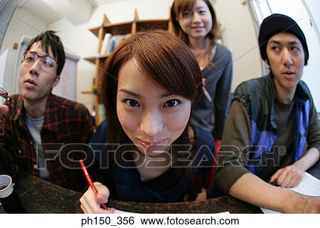 Stock Photograph - Portrait of a businesswoman with her colleges in an office. Fotosearch