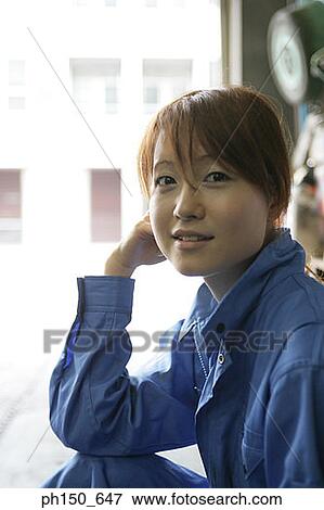 Portrait of a female auto mechanic sitting in an auto repair shop View Large Photo Image Stock Photo - Portrait of a female auto mechanic sitting in an auto repair shop. Fotosearch
