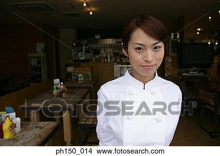 Portrait of a female chef standing in a restaurant View Large Photo Image Picture - Portrait of a female chef standing in a restaurant. Fotosearch